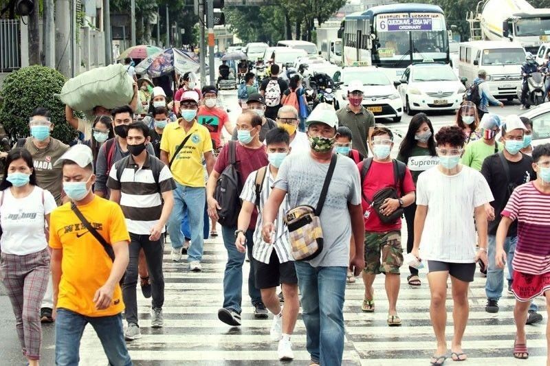This undated photo shows individuals wearing face masks crossing the road (Photo courtesy of The STAR/Michael Varcas)