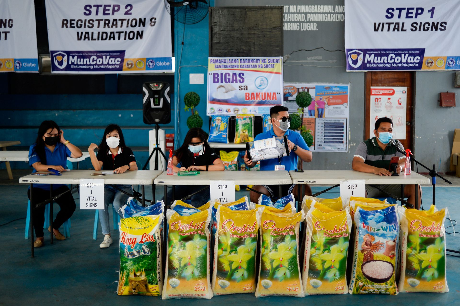 Village officials hold the weekly raffle draw of sacks of rice for residents vaccinated against the coronavirus disease (COVID-19), at the Barangay Sucat Covered Court, in Muntinlupa City, Metro Manila, Philippines, June 20, 2021. (Photo courtesy of REUTERS/Lisa Marie David)