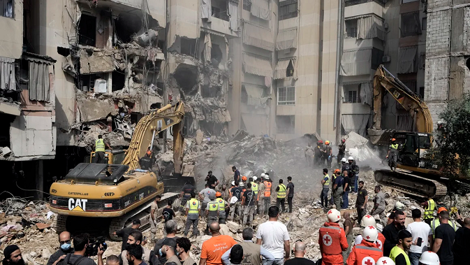 Emergency workers use excavators to clear the rubble at the site of Friday's Israeli strike in Beirut's southern suburbs, Saturday, Sept. 21, 2024.  Bilal Hussein/AP