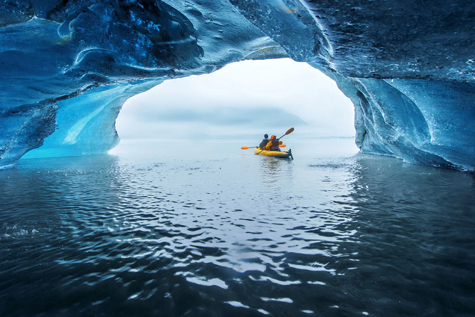 Tourist kayaking inside a floating iceberg from the Valdez Glacier in Alaska.  Piriya Wongkongkathep/Moment Editorial/Flickr Vision/Getty Images