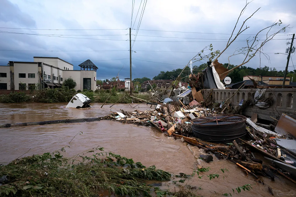 A van sits in floodwaters near the Biltmore Village in Asheville, North Carolina, in the aftermath of Hurricane Helene on September 28, 2024. Sean Rayford/Getty Images