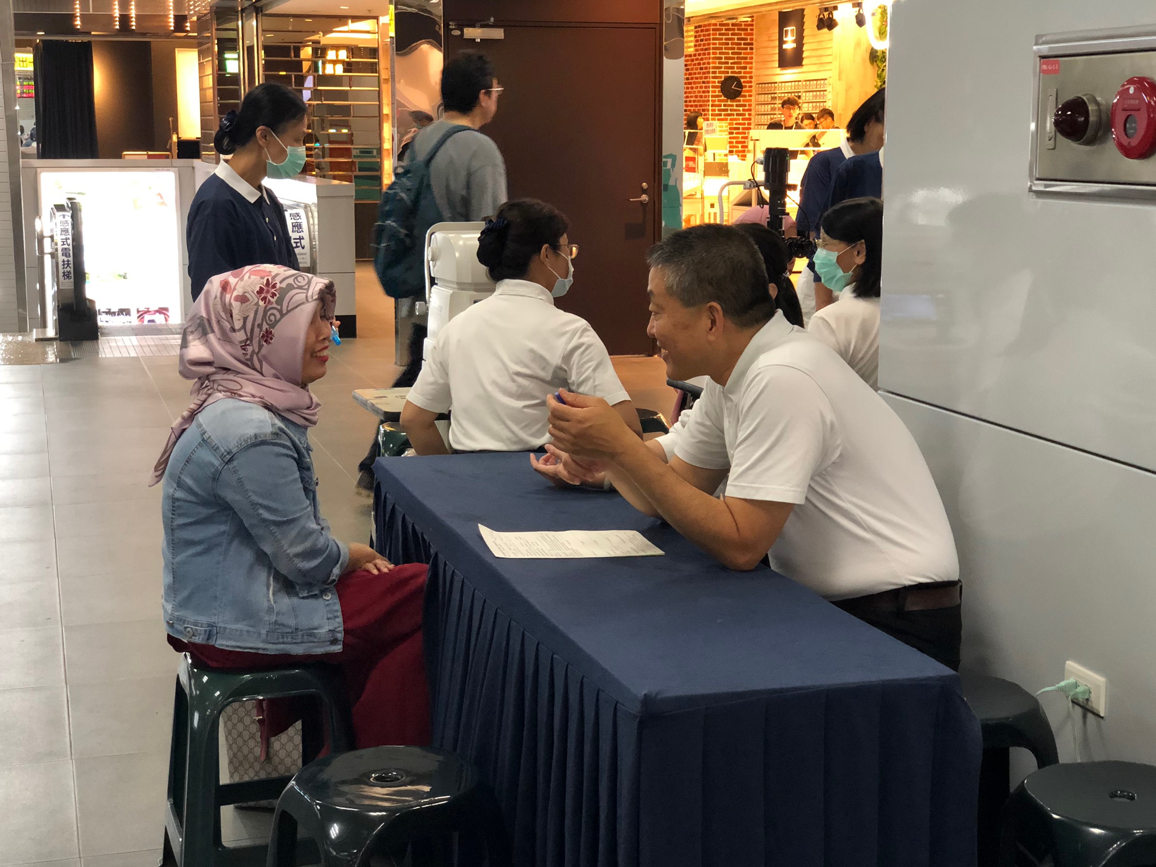 Migrant workers join health examination at Taipei Main Station.