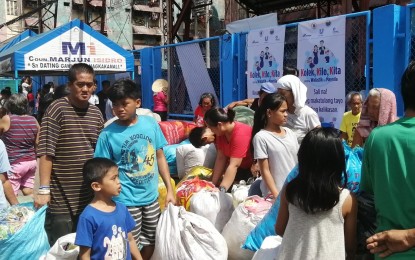 Residents fall in line waiting for their turn to weigh their plastic wastes in Manila. Attribute: PNA