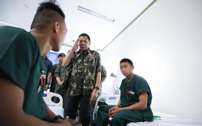  President Rodrigo Duterte salutes one of the wounded soldiers he visited at the Camp Teodulfo Bautista Station Hospital in Jolo, Sulu Saturday (Dec. 14, 2019). Photograph: PNA