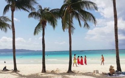 Tourists, mostly foreigners, enjoy the sun and beach in the famed Boracay Island in the Philippines. Source: PNA
