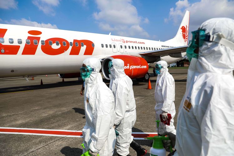 Petugas kebersihan bandara disamping pesawat Lion Air Boeing 737-800 setelah melakukan sterilisasi di Bandara Soekarno Hatta