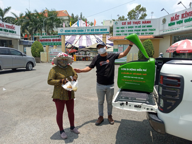 các tình nguyện viên còn dùng cả ô tô chở các suất cơm đến các tụ điểm đông người qua lại để tham gia phát cơm miễn phí