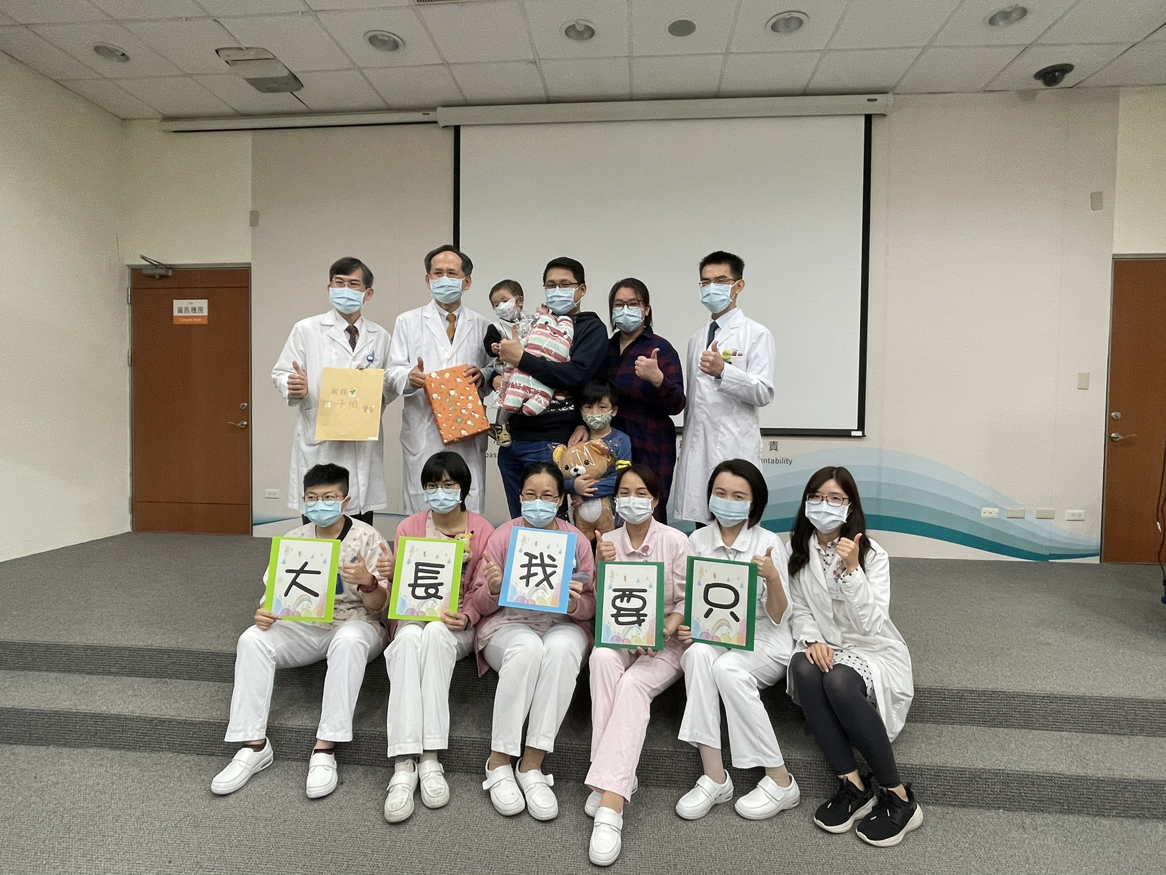 The 21-month-old Malaysian child with Taichung Veterans General Hospital doctors and nurses that helped him. Image by Taichung Veterans General Hospital.   