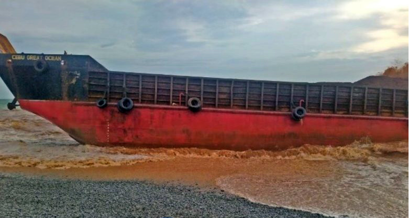 Seven crew members rescued after Philippine cargo ship runs aground after Typhoon. Image courtesy of Philippines Coast Guard. 